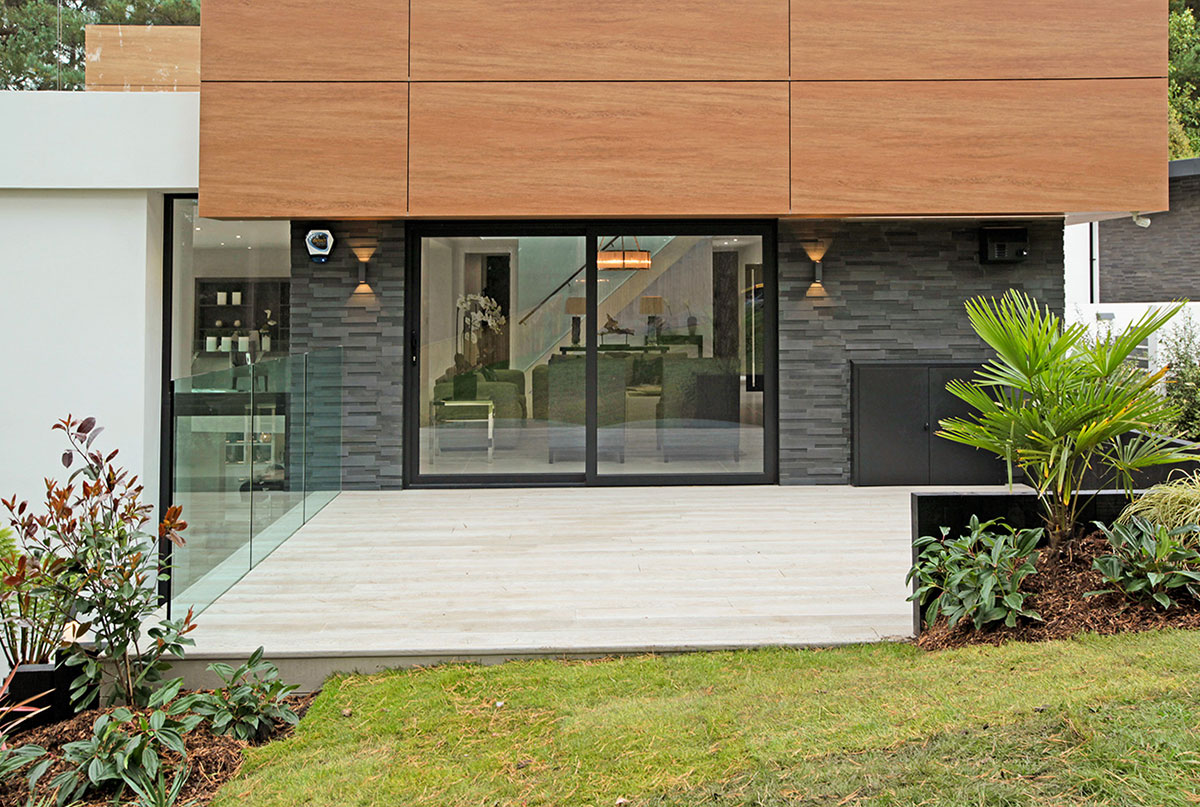 Norstone's Brand New Aksent 3D Panels in Ash Grey Basalt Stone used on an exterior entryway wall