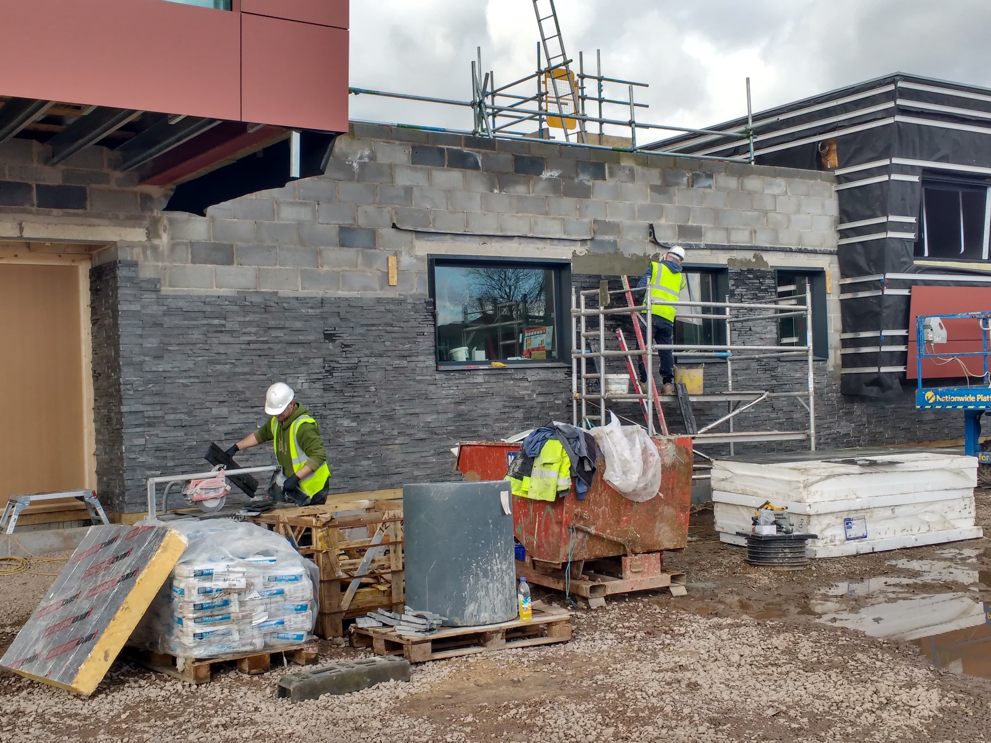 Installers working on a commercial stone veneer installation