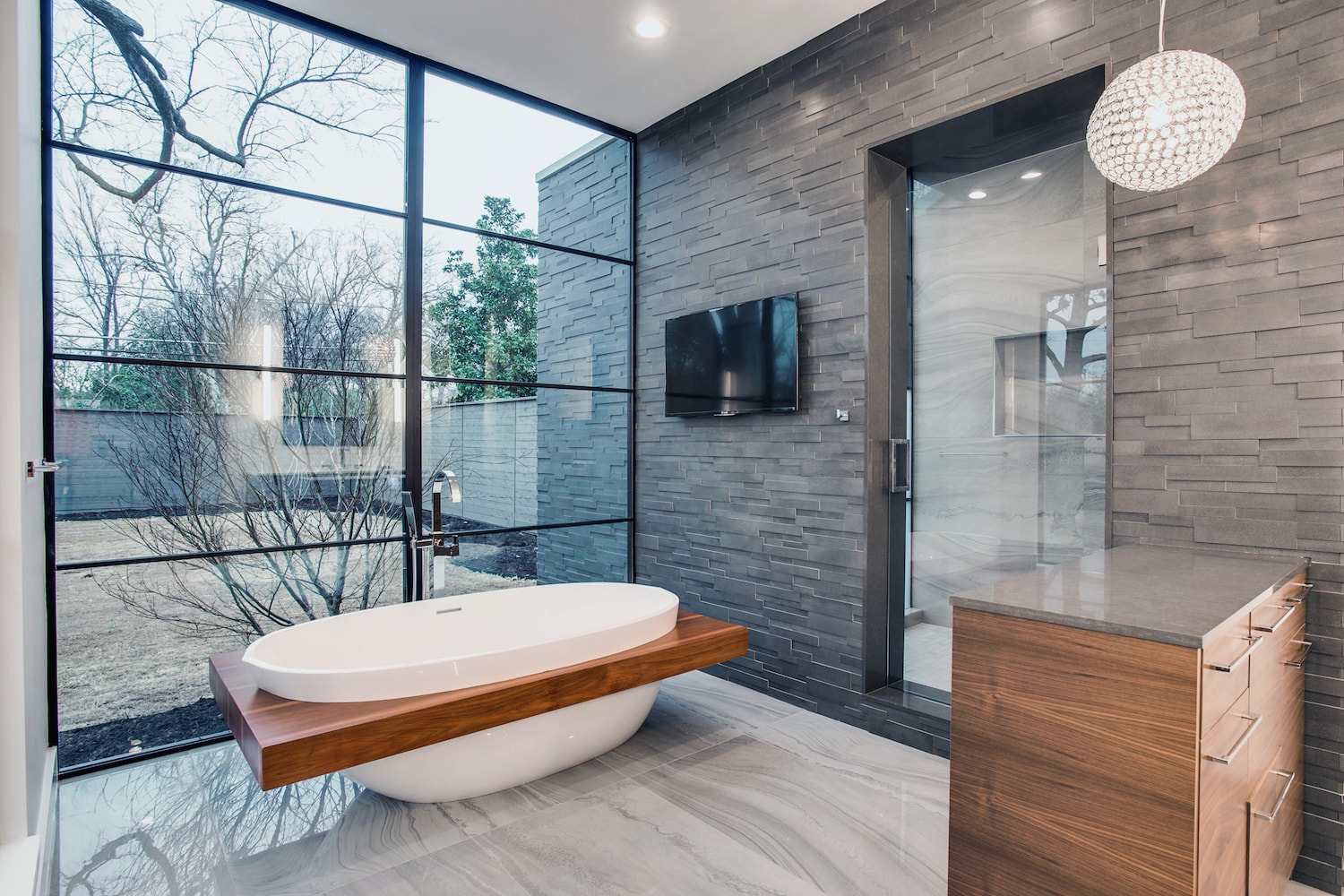 Luxury Modern Master bathroom with marble floors and honed grey stone veneer wall in Dallas