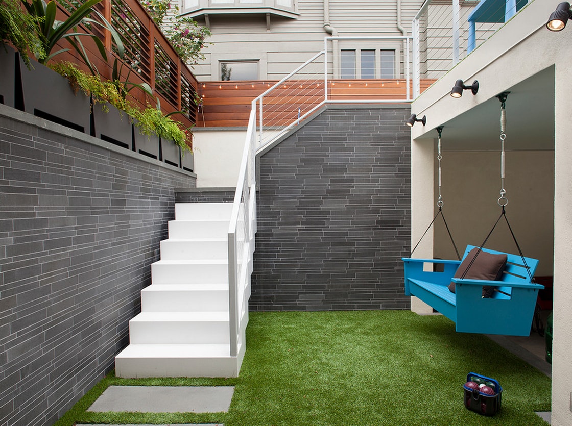 City Backyard in San Francisco featuring artificial turf and a grey interlocking tile feature wall